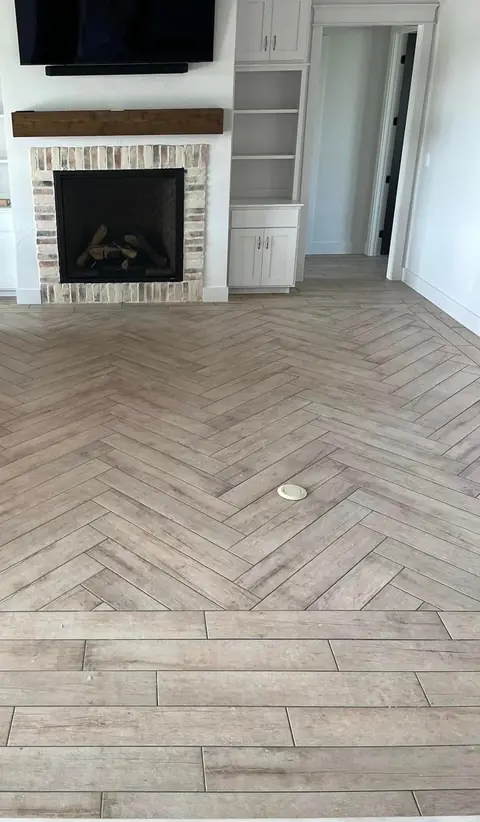 Herringbone wood-look tile floor in a living room