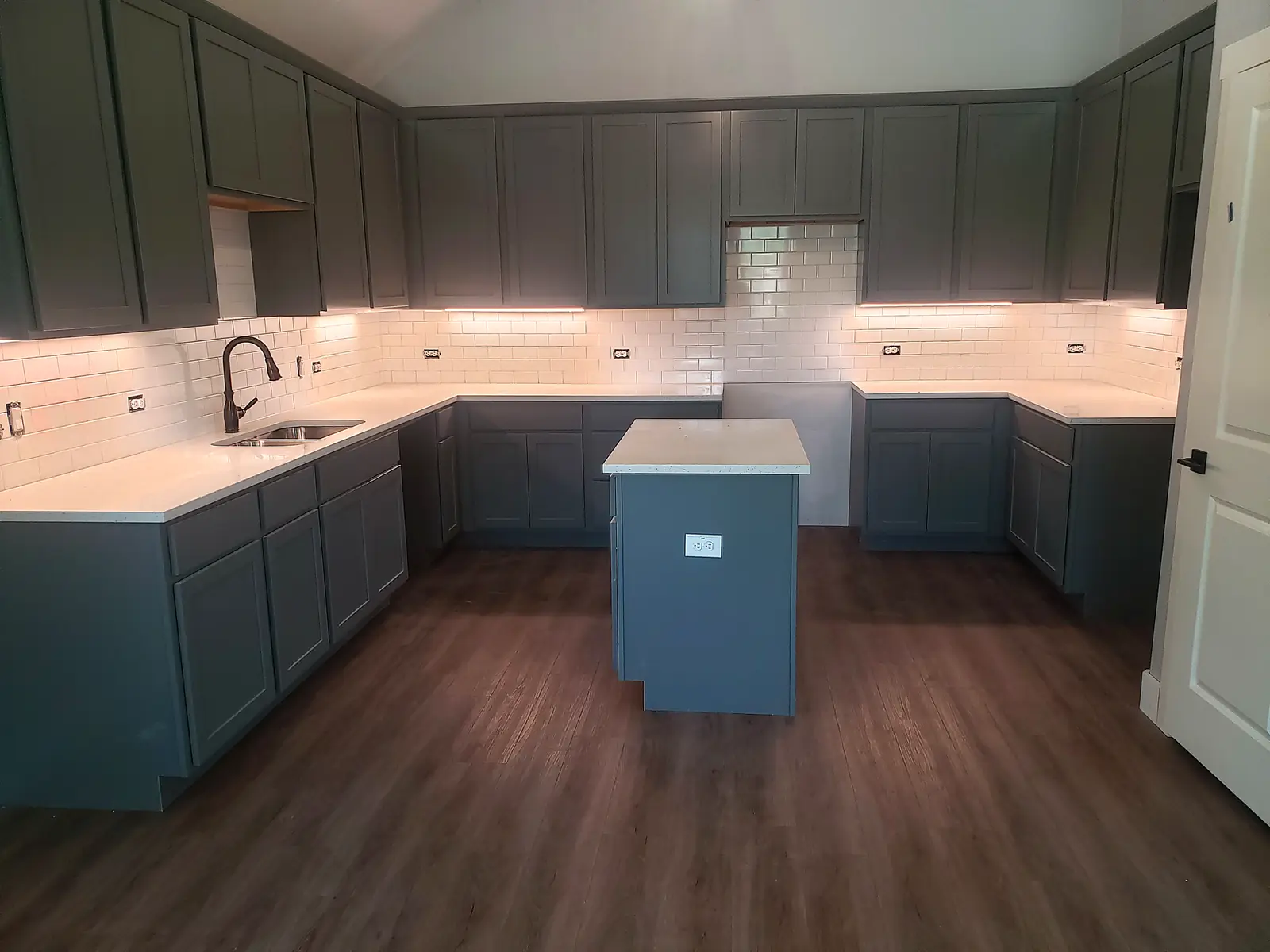 Finished kitchen remodel with quartz counters, island and new flooring