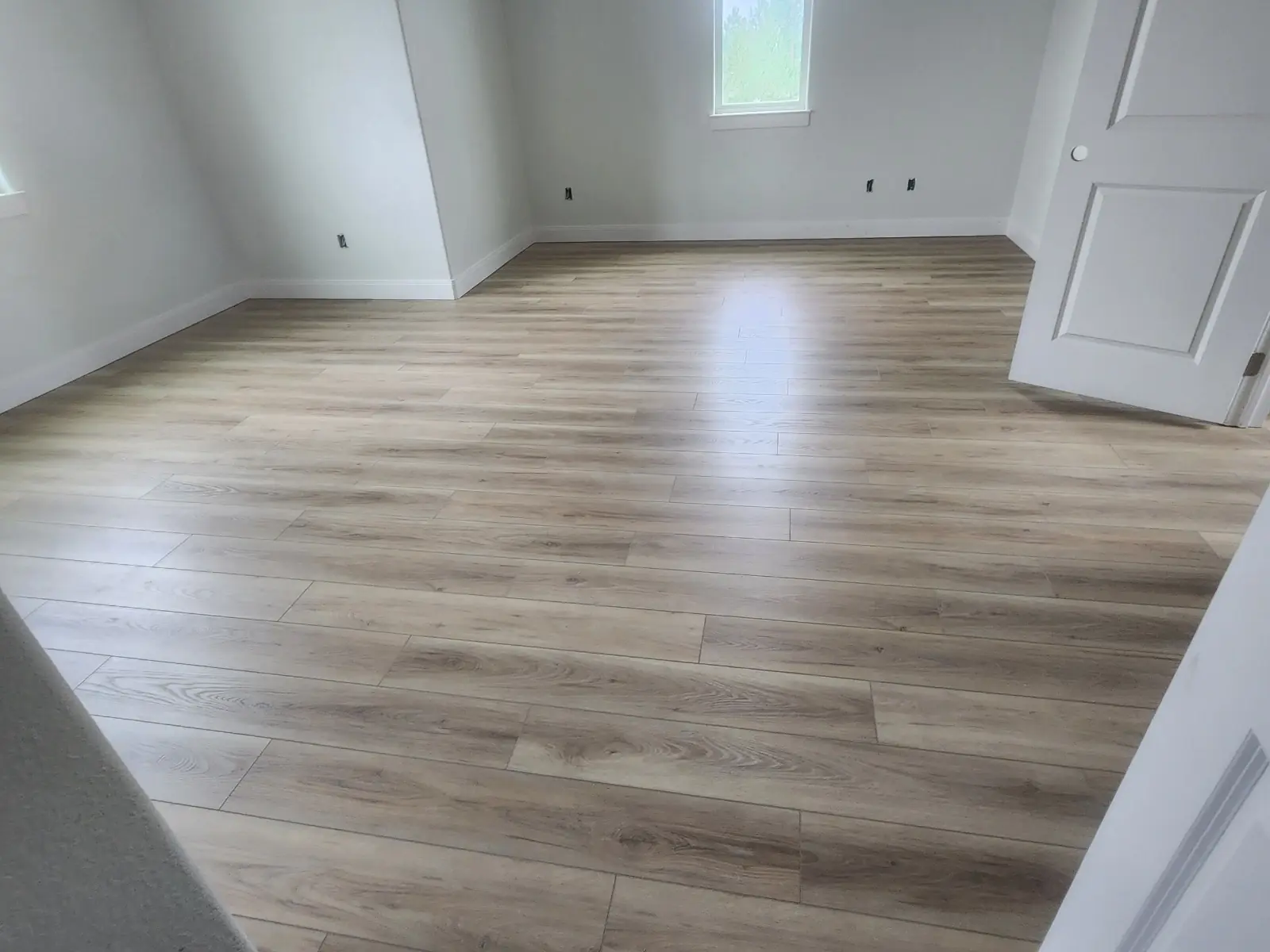 Wide plank vinyl flooring installed through connected rooms