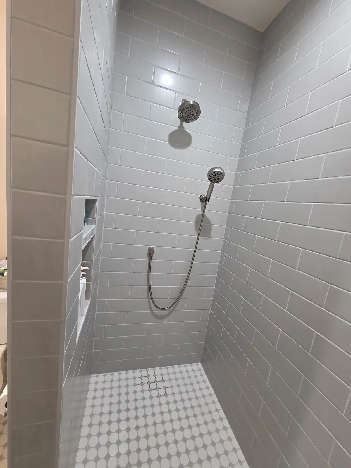 Subway tile shower with mosaic accent floor