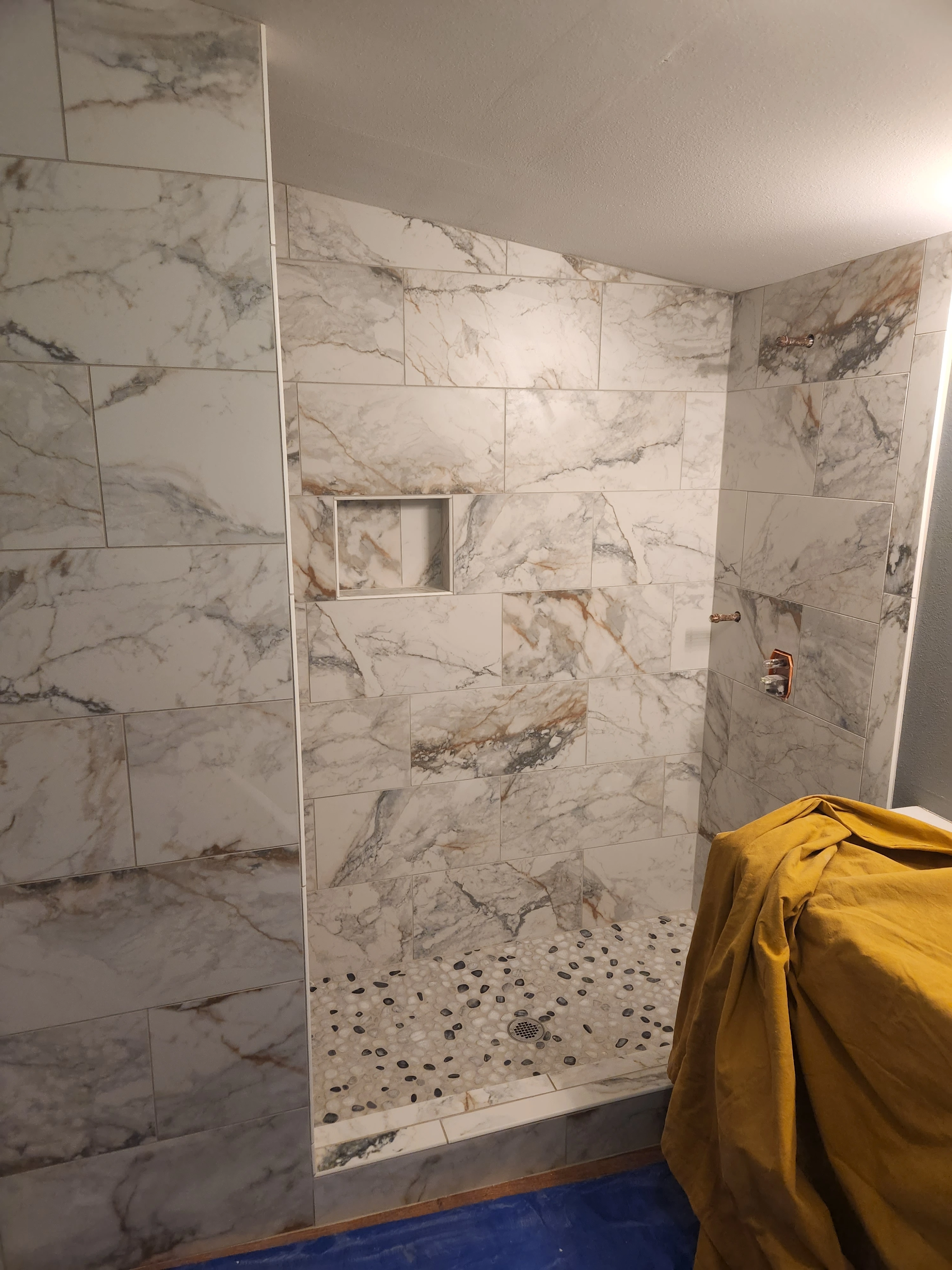 Marble look tile shower installation