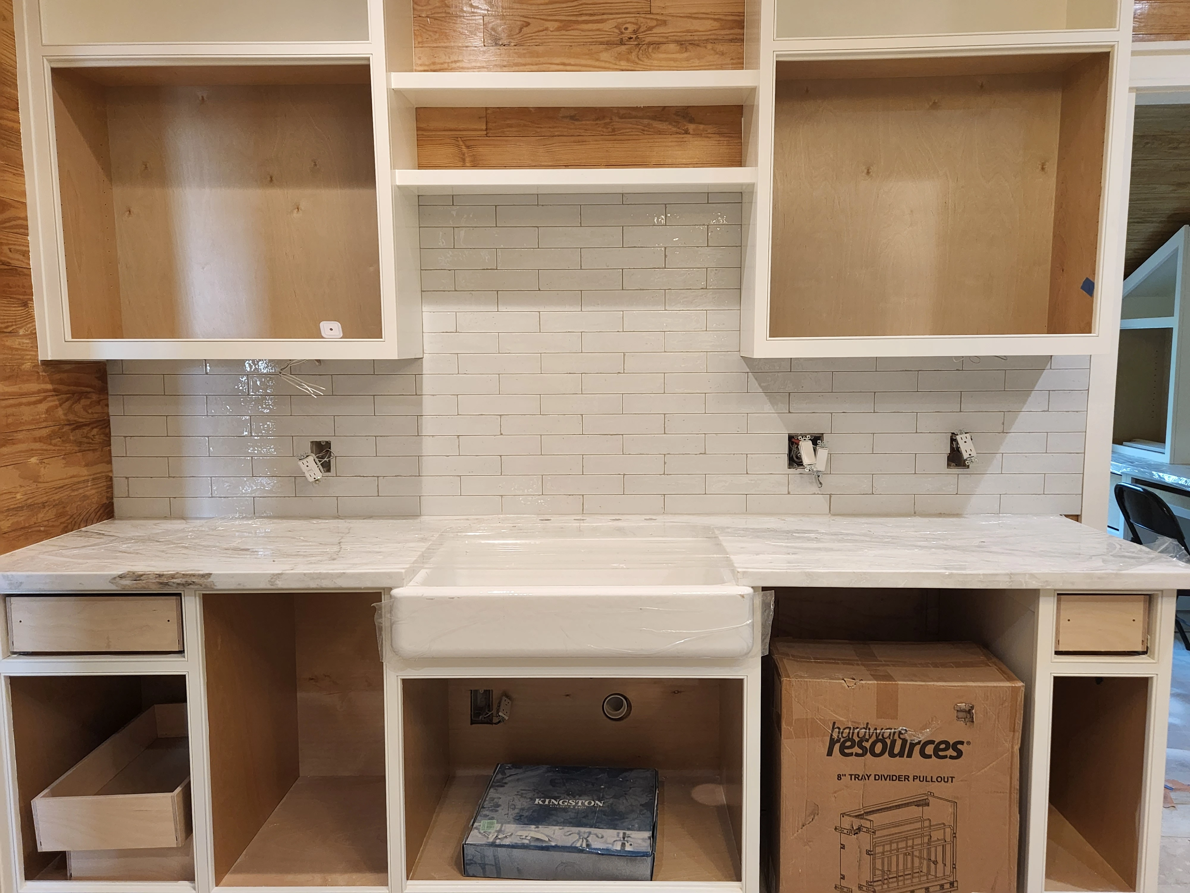 Kitchen countertop and backsplash installation with farmhouse sink